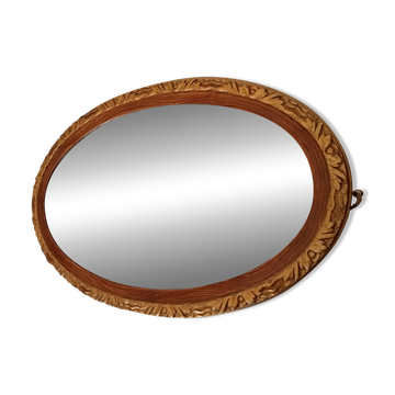 Antique oval mirror with beveled glass in wood and stucco, 19th century
