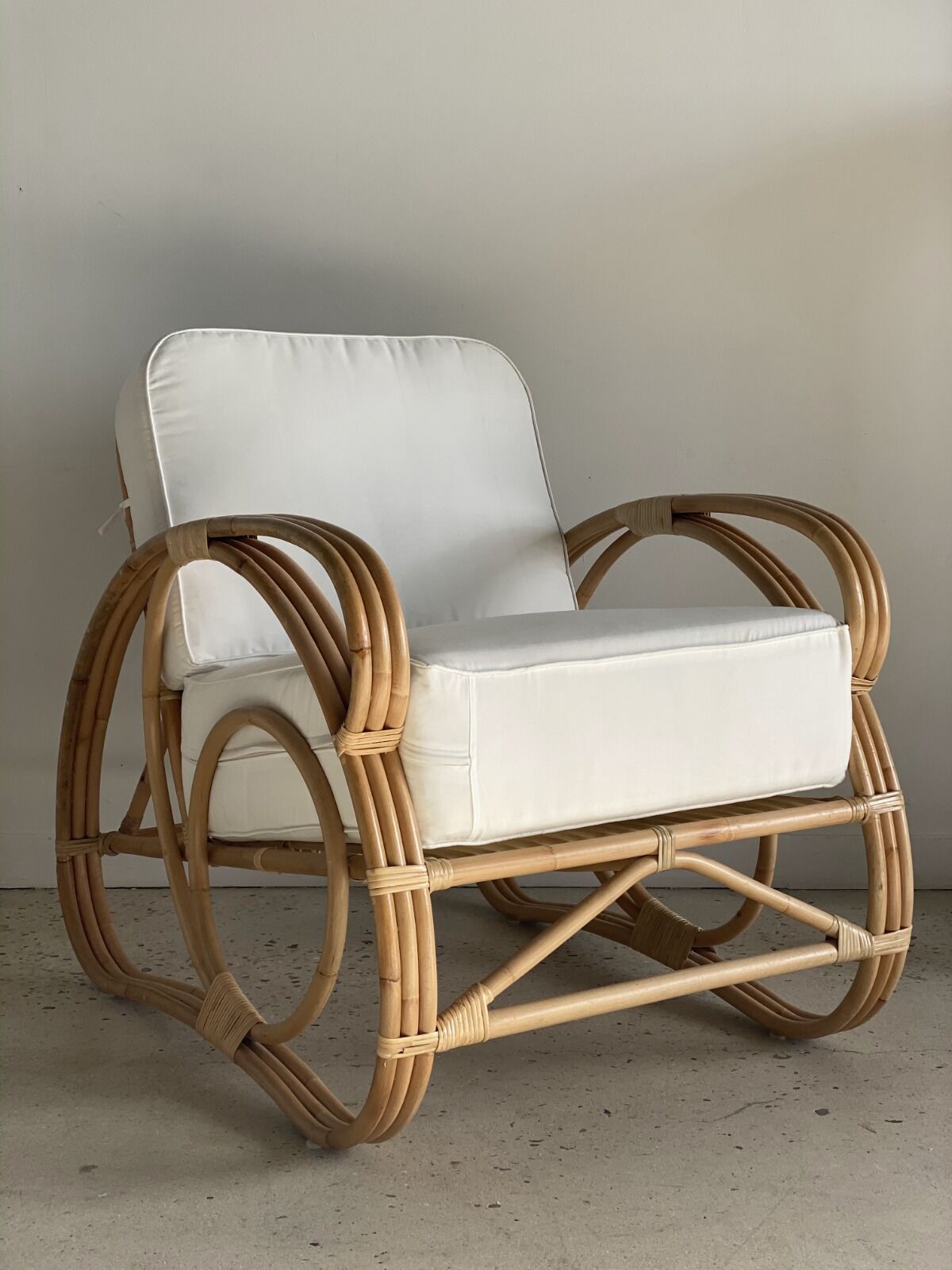 Large rattan rest chair and white cushions