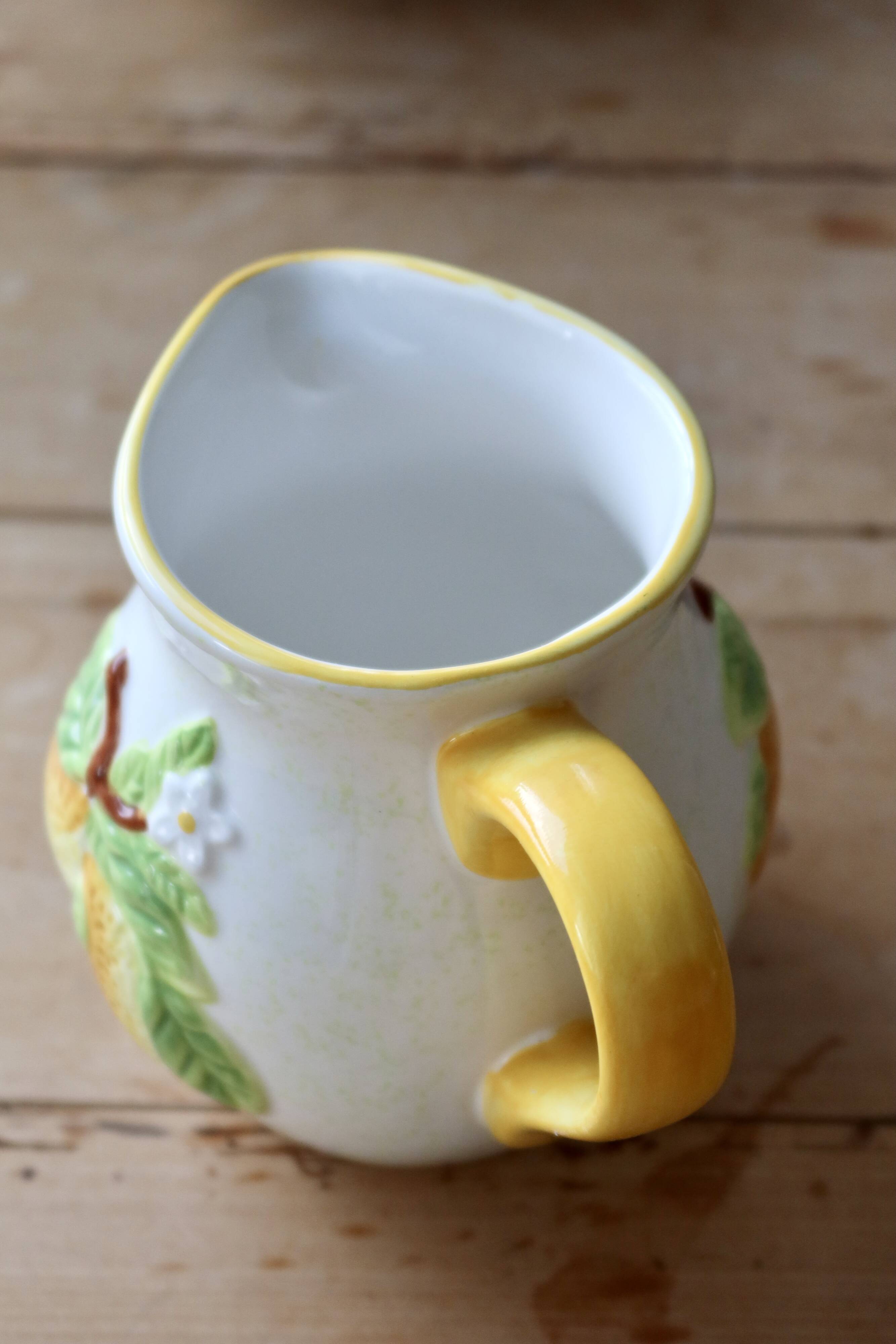 Vintage earthenware and slip pitcher with lemon motif