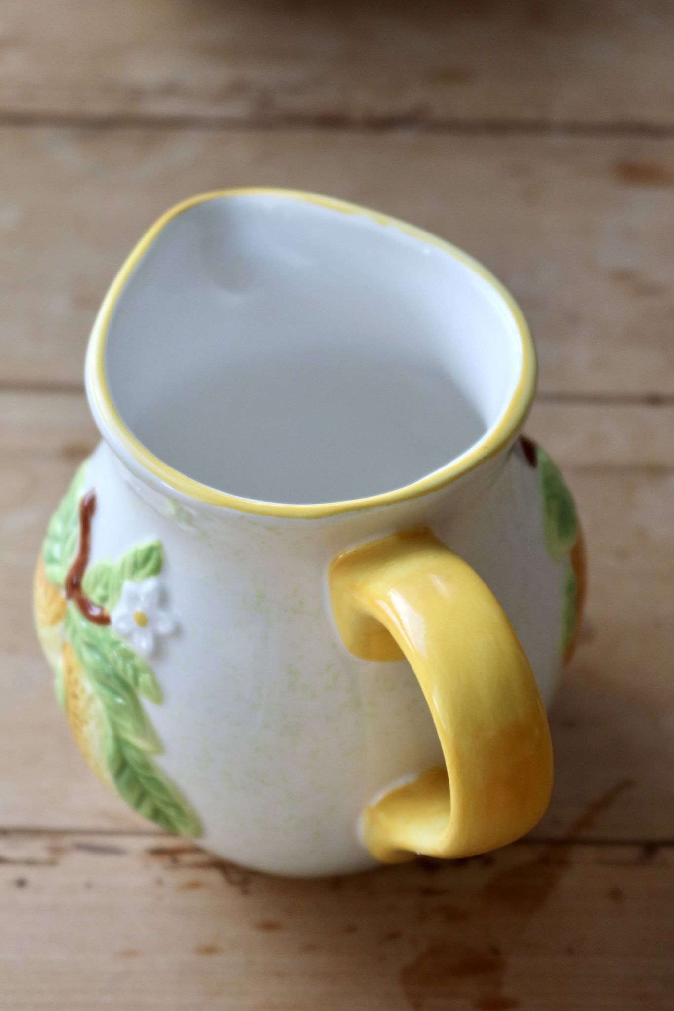 Vintage earthenware and slip pitcher with lemon motif