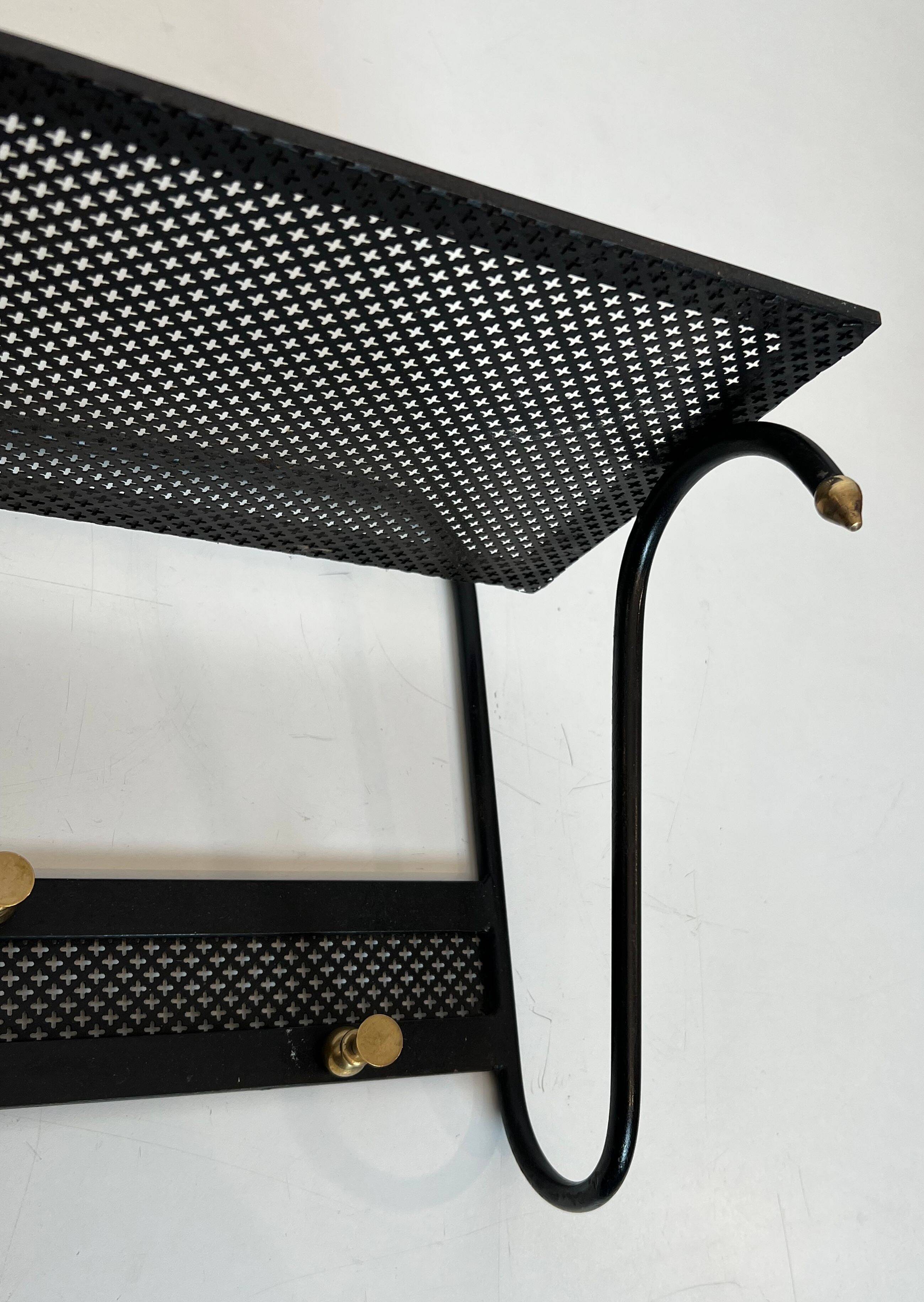 Coat rack in black lacquered metal, perforated sheet metal and brass in the style of Mathieu Matégot