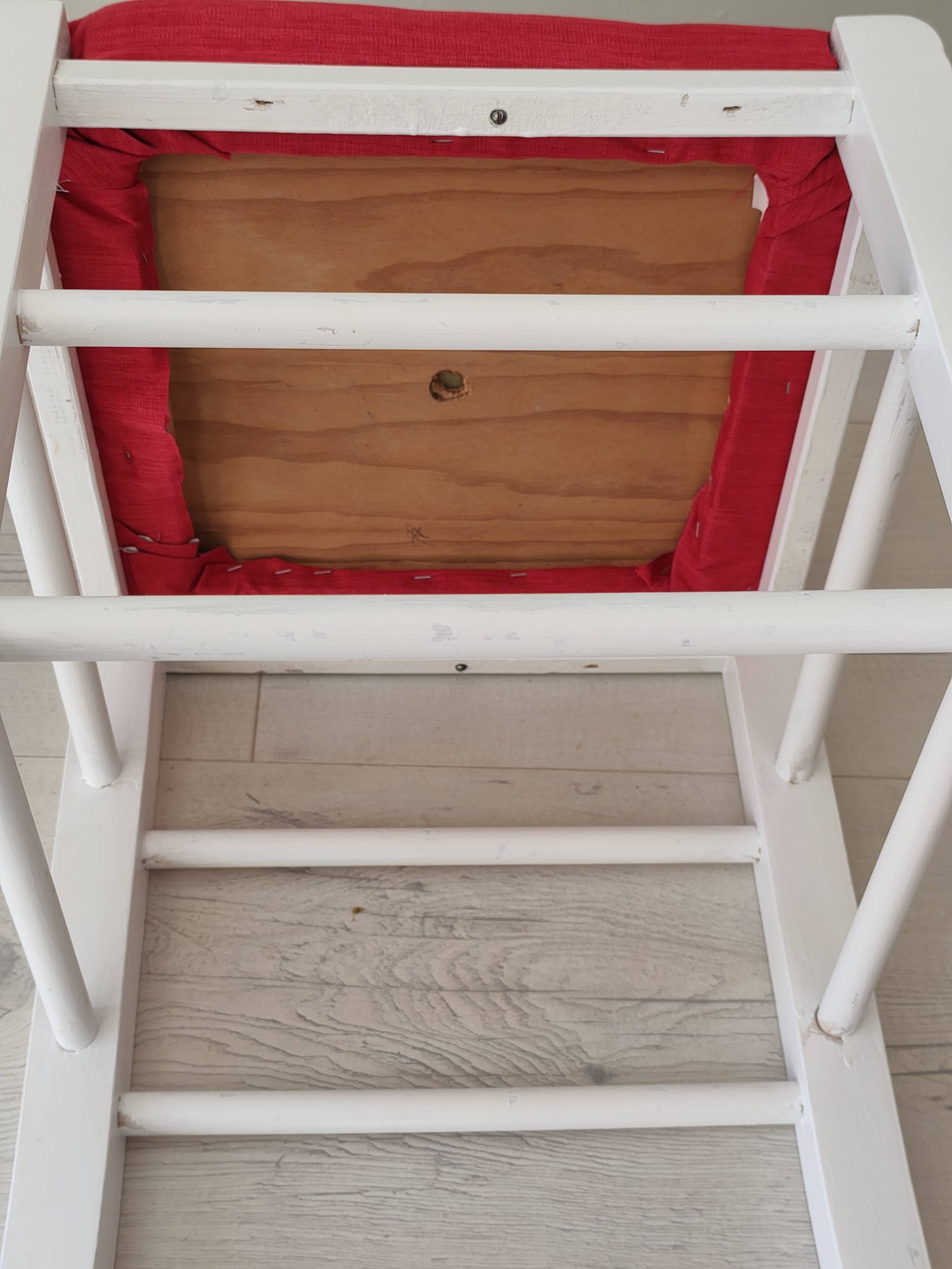 White pine stool with a red seat.