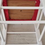 White pine stool with a red seat.