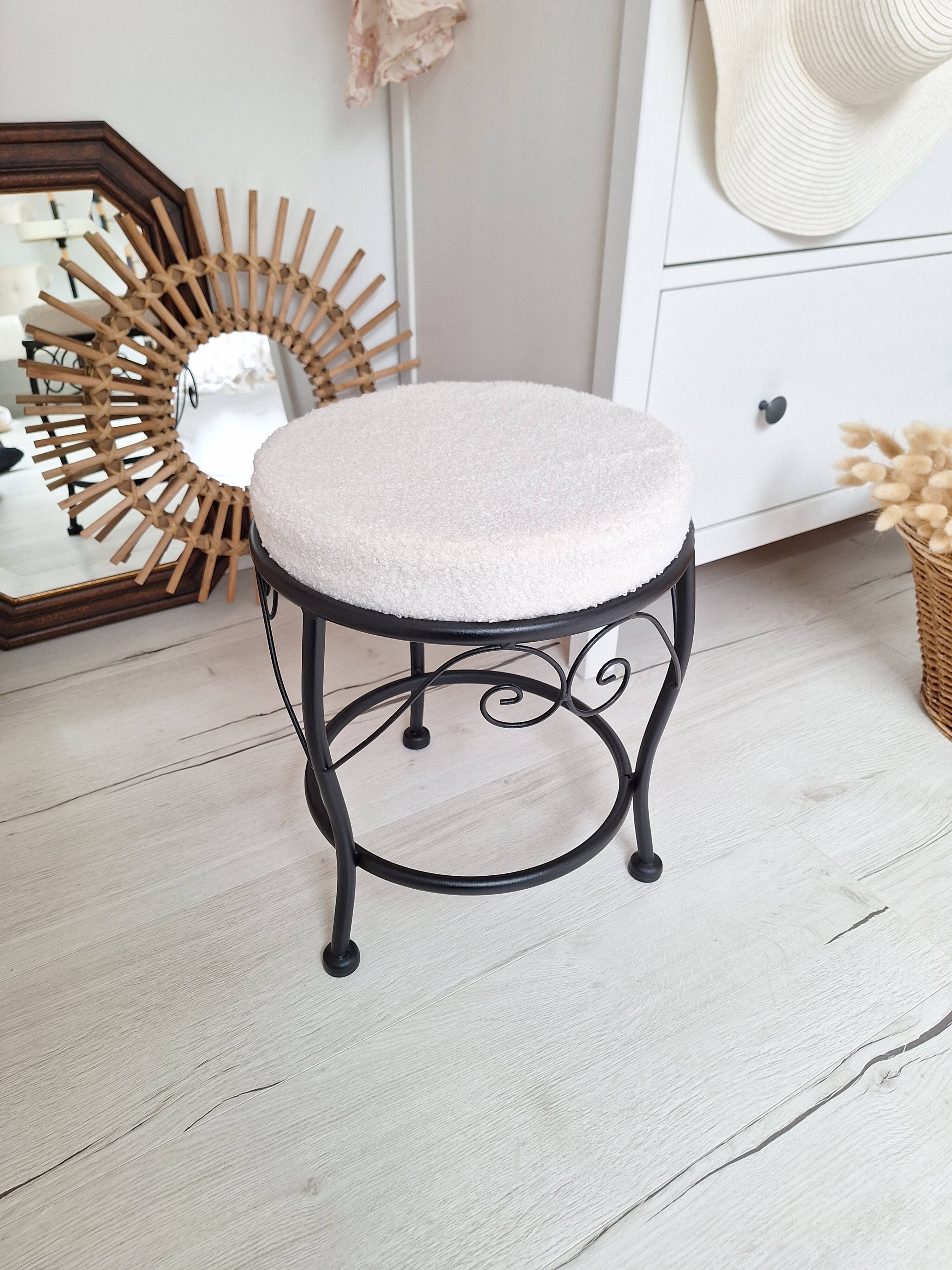 Black iron stool/pouf with its boucle fabric cushion.