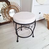Black iron stool/pouf with its boucle fabric cushion.