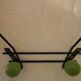 Small wrought iron coat rack with wooden balls.