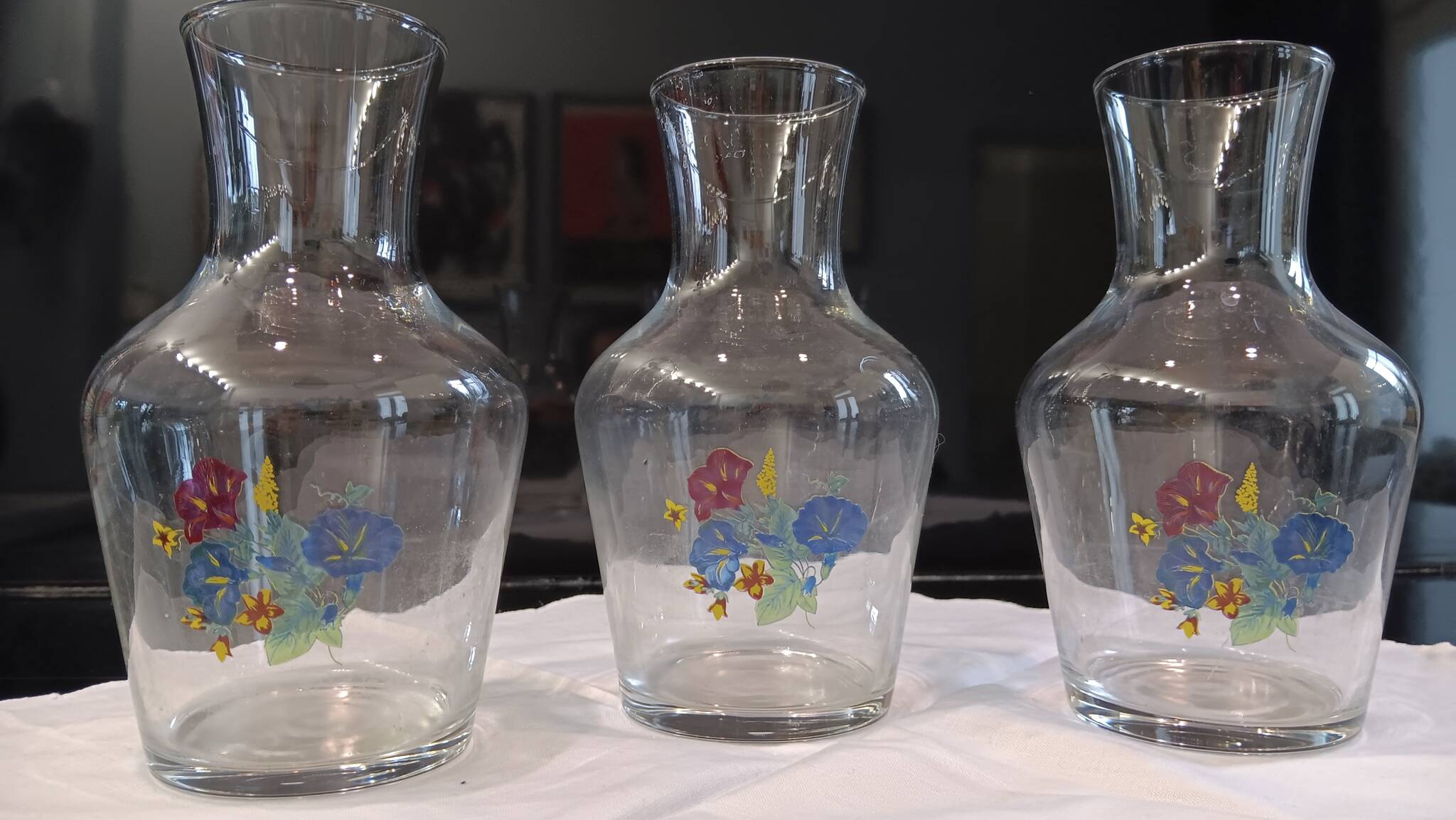 3 glass carafes, vintage. Very pretty floral pattern.