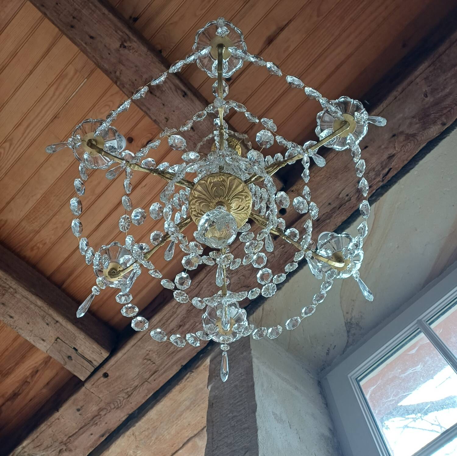 Antique chandelier with pendants in bronze and crystal.