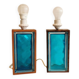 Two Swedish table lamps in solid pressed blue glass and teak wood "frame".