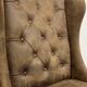 Upholstered armchair in brown imitation leather