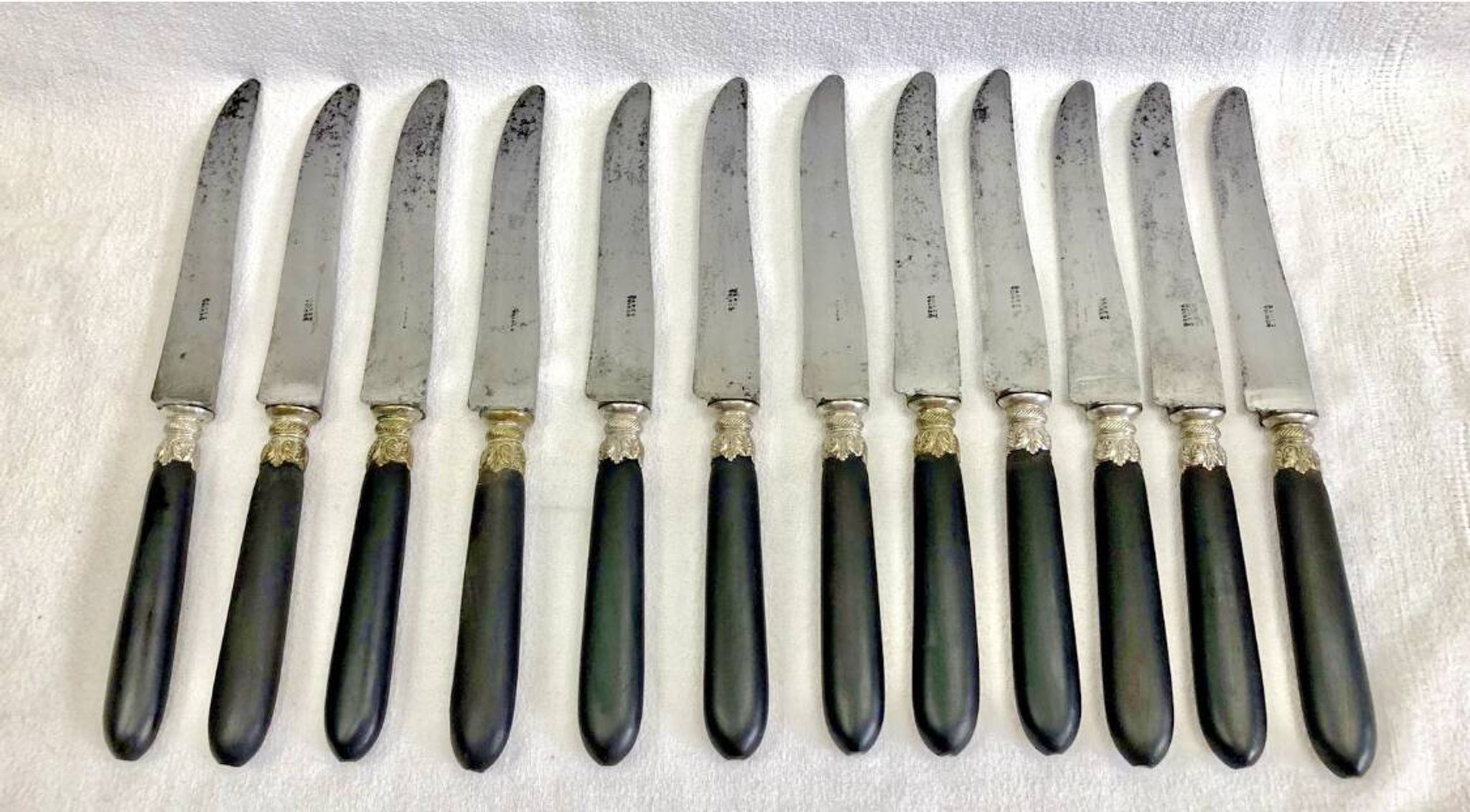 12 antique large table knives with ebony handles from the Napoleonic III period.