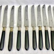 12 antique large table knives with ebony handles from the Napoleonic III period.