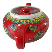 Vintage red Chinese teapot decorated with dragons and symbols.