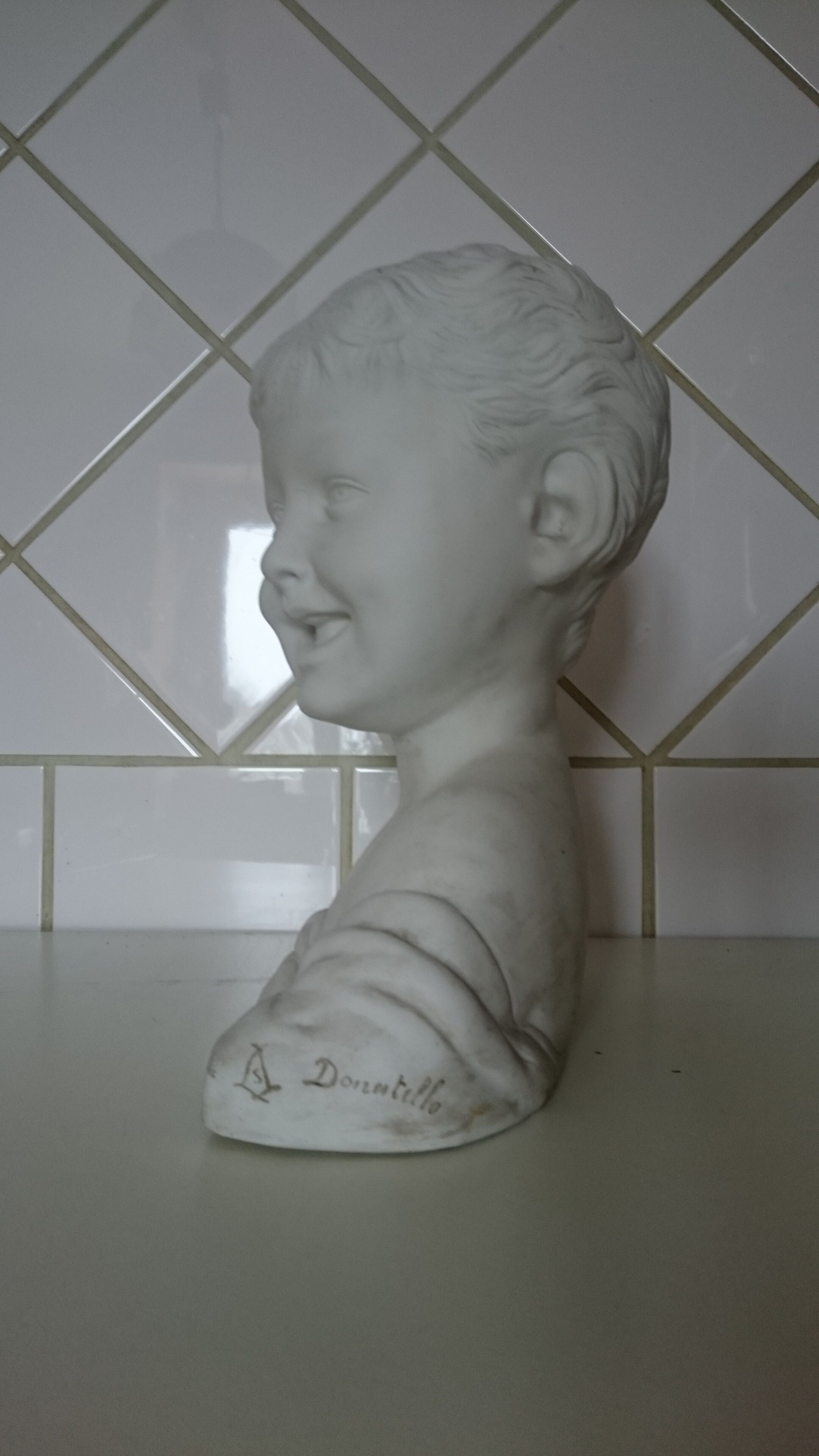 Laughing child bust after Donatello in Sèvres biscuit