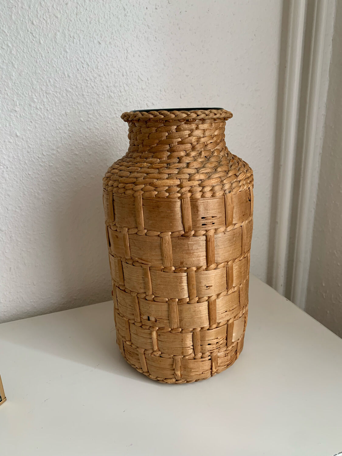 Green glass jar with wickerwork