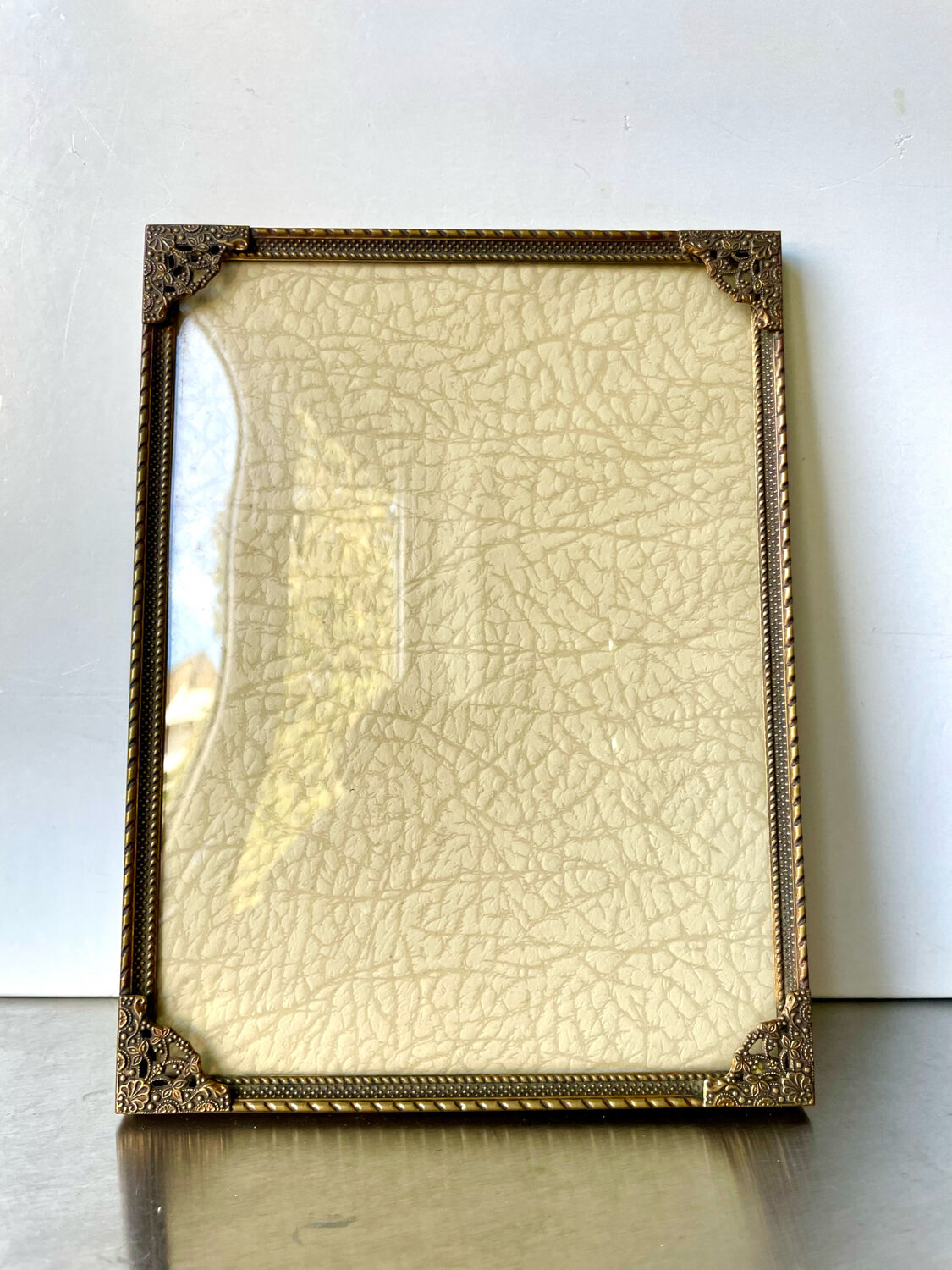 Metal frame in gold colored brass