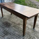 Antique chestnut farmhouse table with 3 drawers on the front.