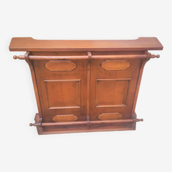 Bar counter in exotic teak wood; decor of molded panels