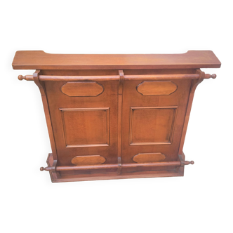 Bar counter in exotic teak wood; decor of molded panels