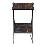 Black metal server and earthenware tiles with geometric patterns