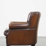 Sheep leather armchair finished with decorative nails