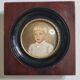 Miniature portrait of a young boy signed, wooden frame with convex glass, 12x12 cm.