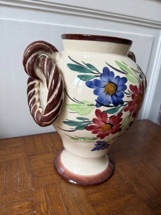 Ceramic vase with hand-painted floral decoration.