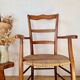 Antique campaign chair in wood and straw