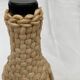 Bottle surrounded by wicker or raffia