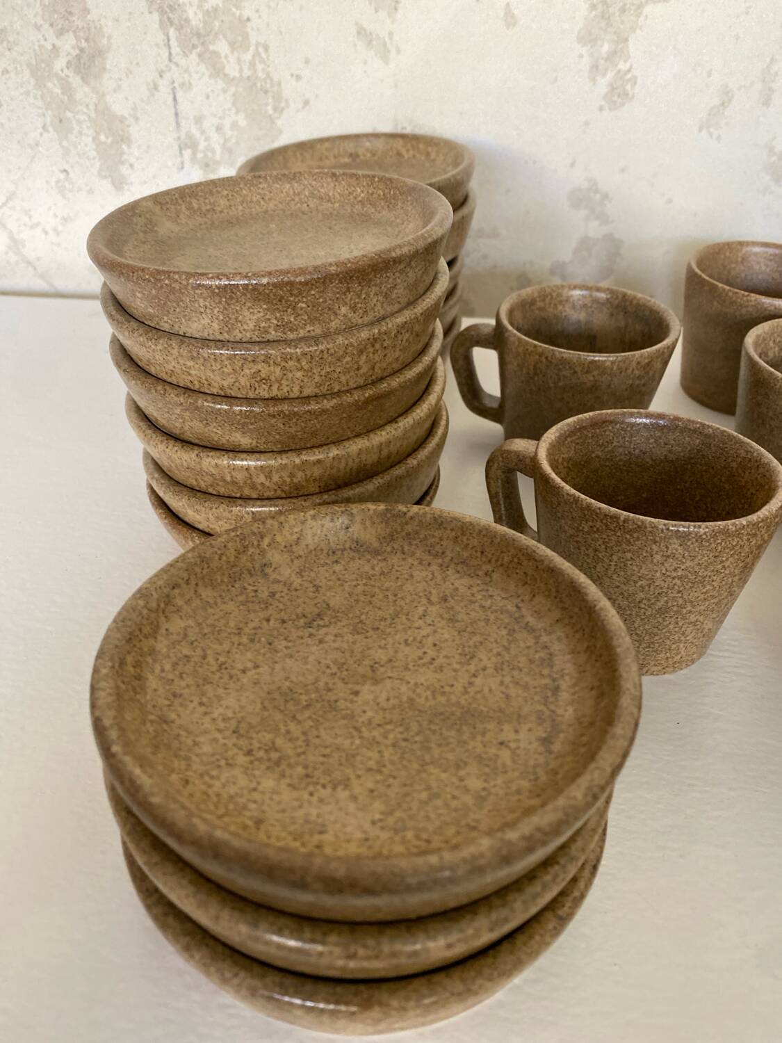 Set of stoneware coffee cups with saucers