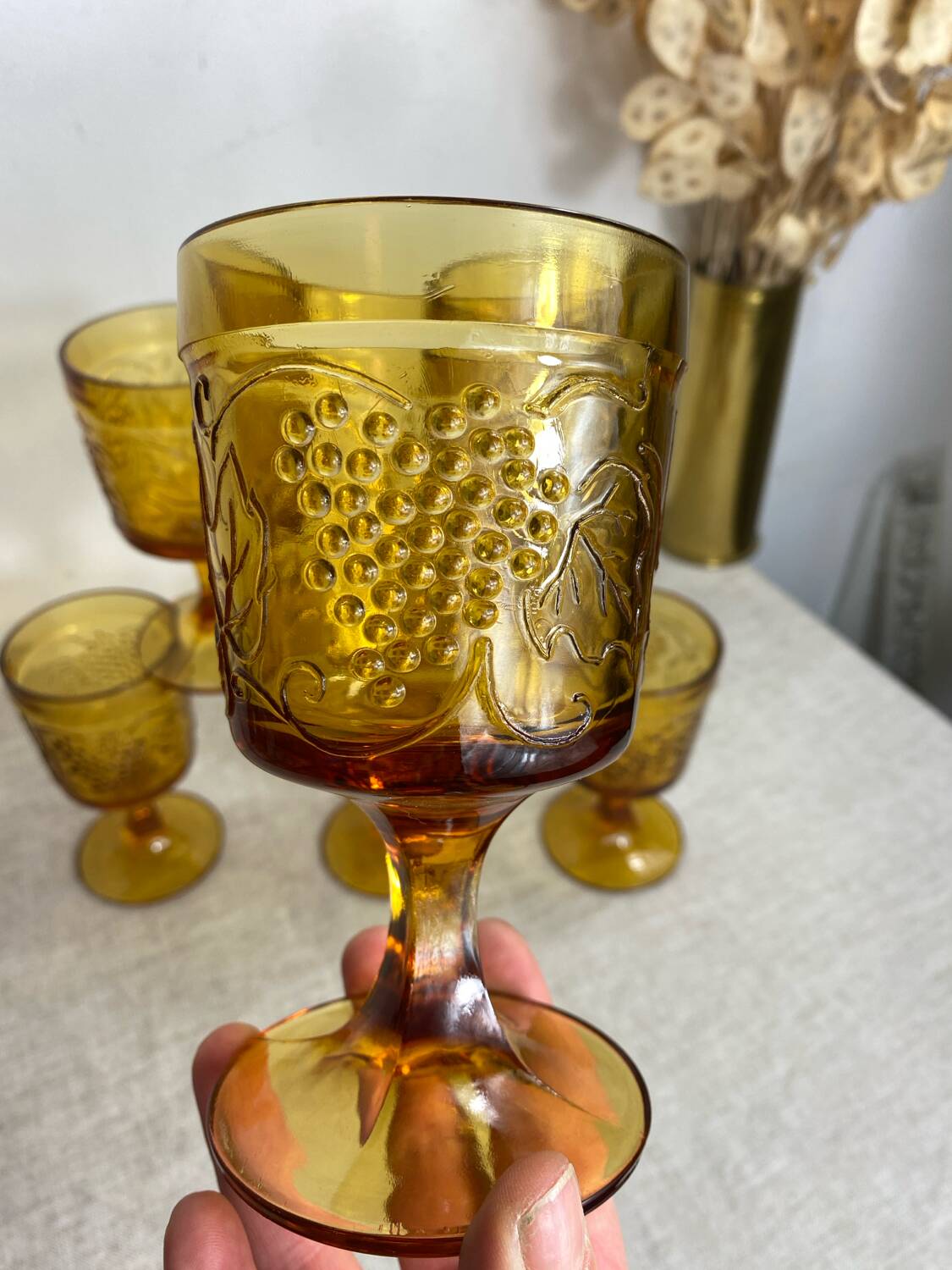 Six stemmed glasses in amber-colored molded glass
