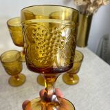 Six stemmed glasses in amber-colored molded glass