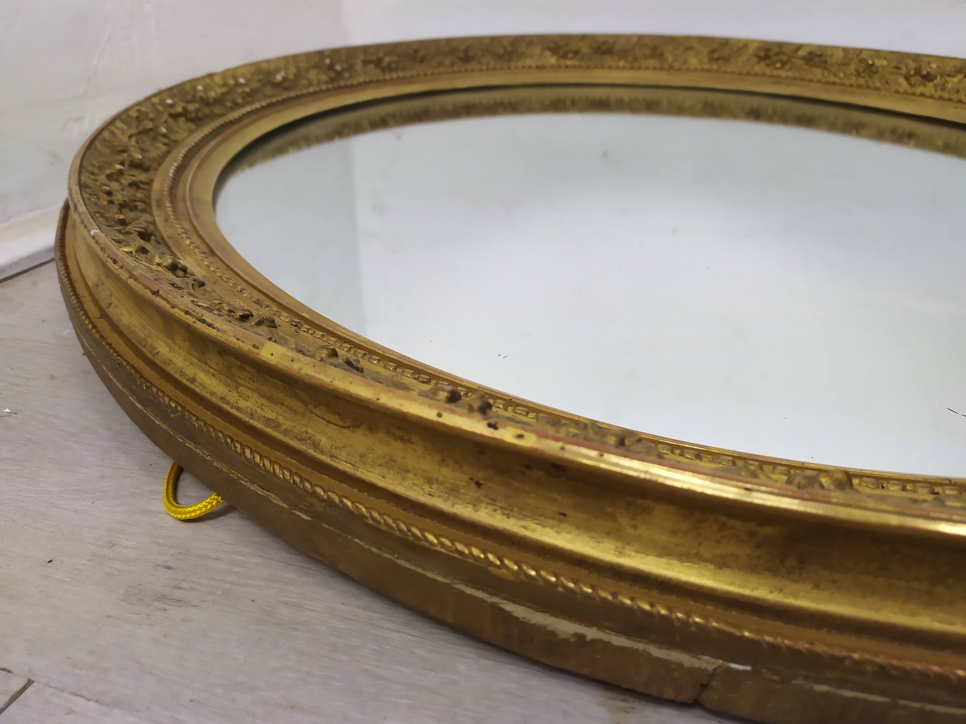 Golden oval mirror