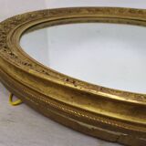 Golden oval mirror