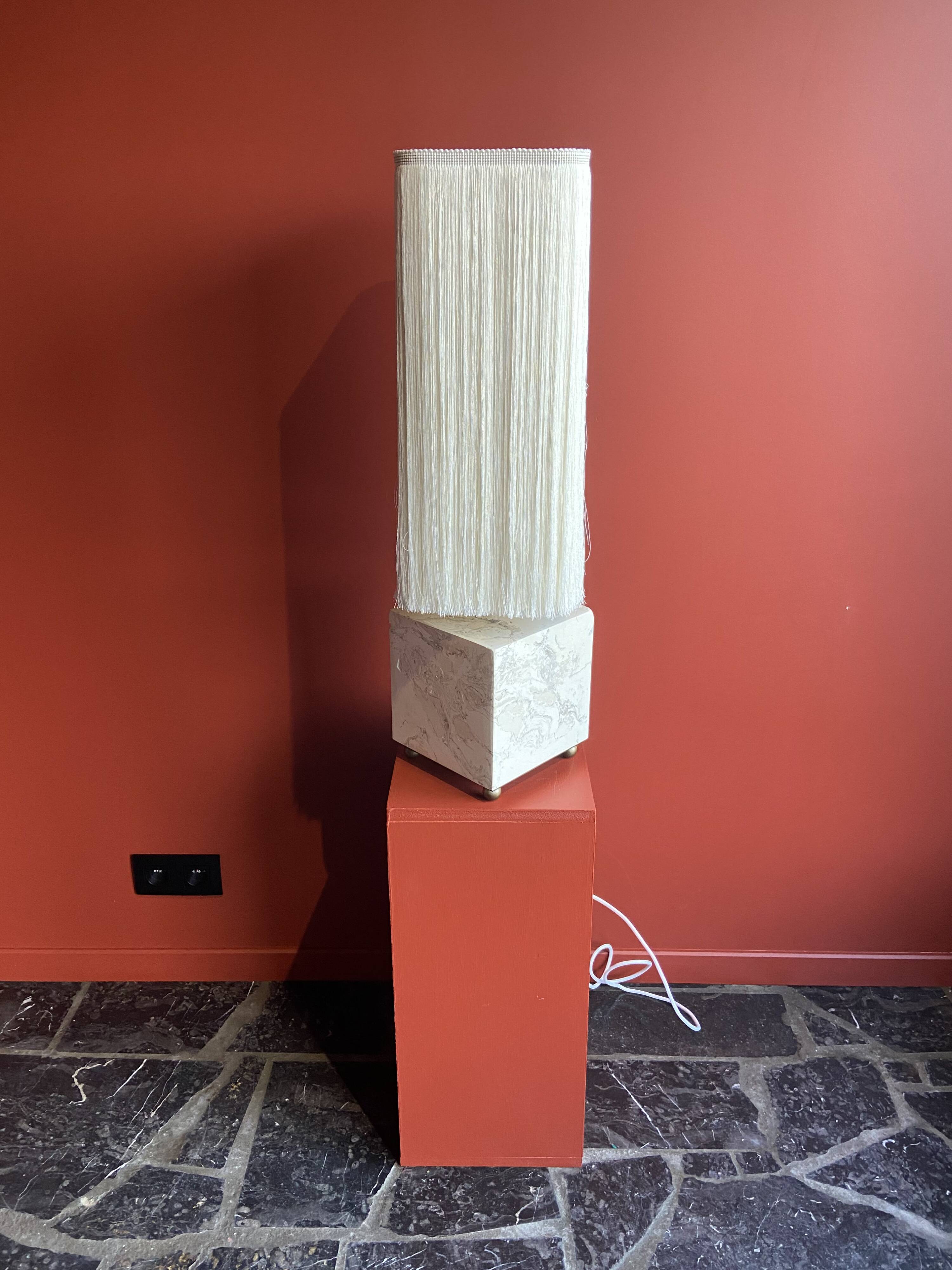 Beige marble stucco base, Houles white ecru fringed lampshade.