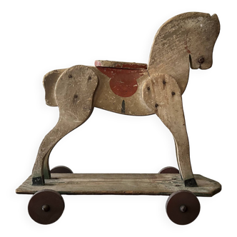 Old/vintage wooden horse toy on wheels from the 1950s