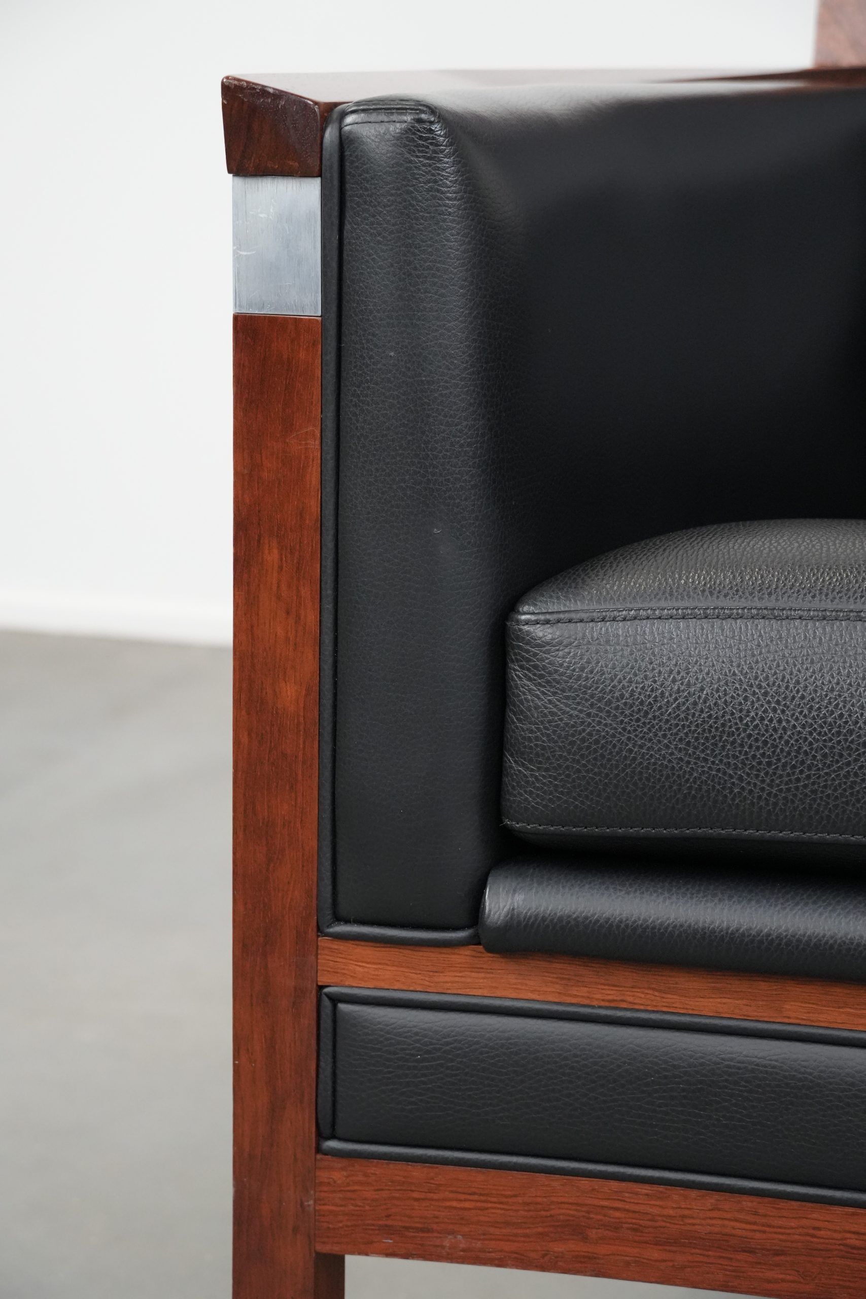 Art Deco design armchair with black leather with decorative stitching