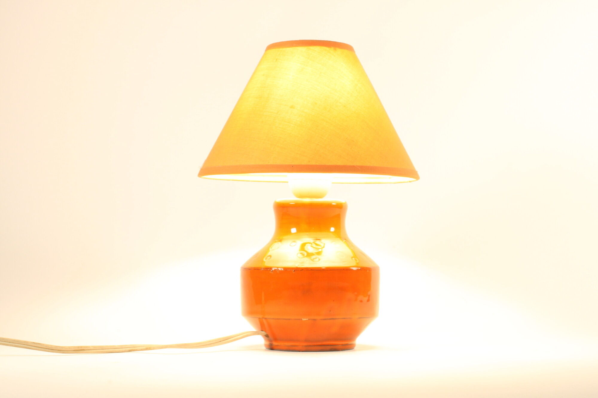 Orange ceramic table lamp with geometric imprints, 1970s.