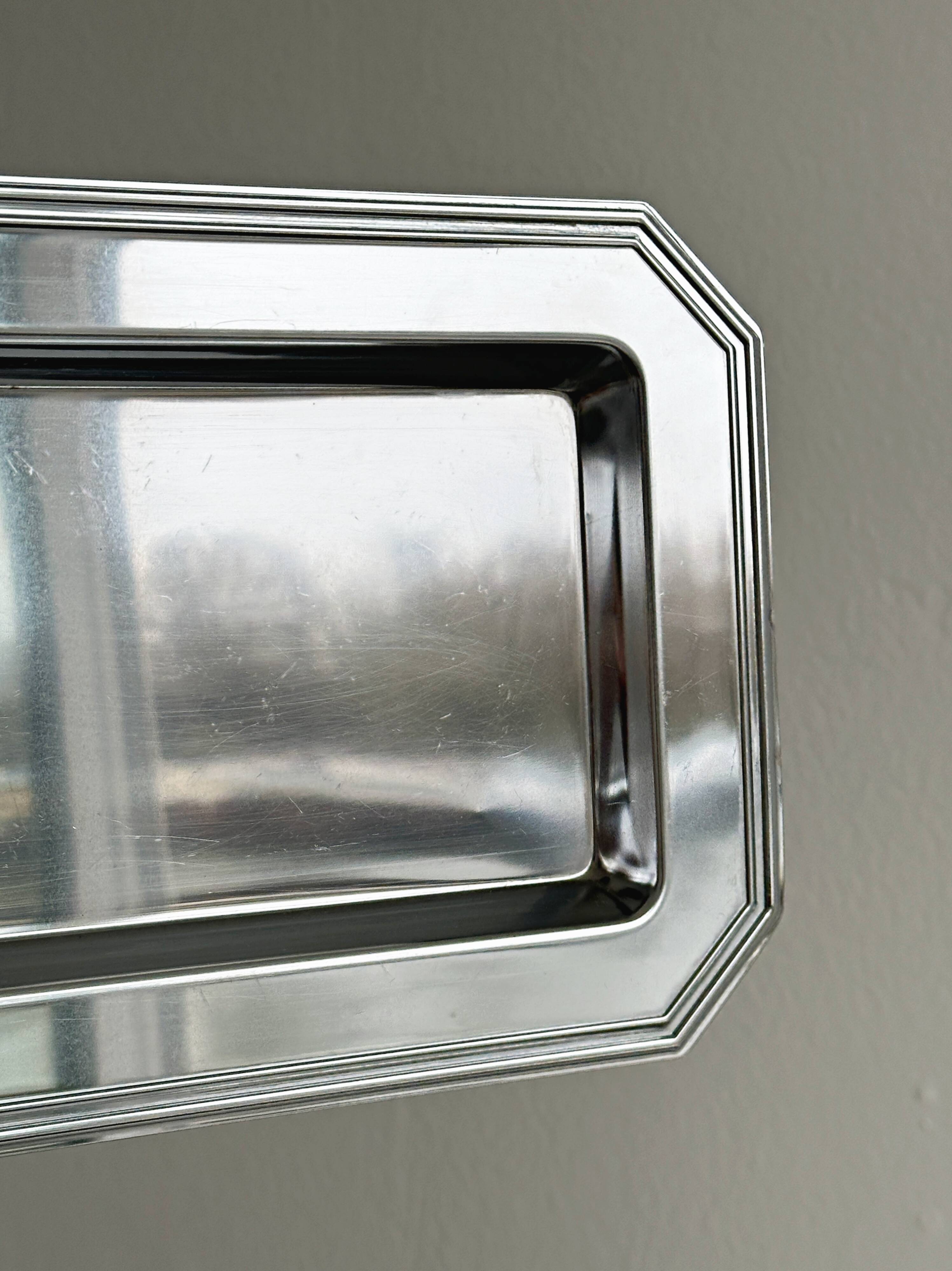 Small rectangular tray made of lightweight metal.