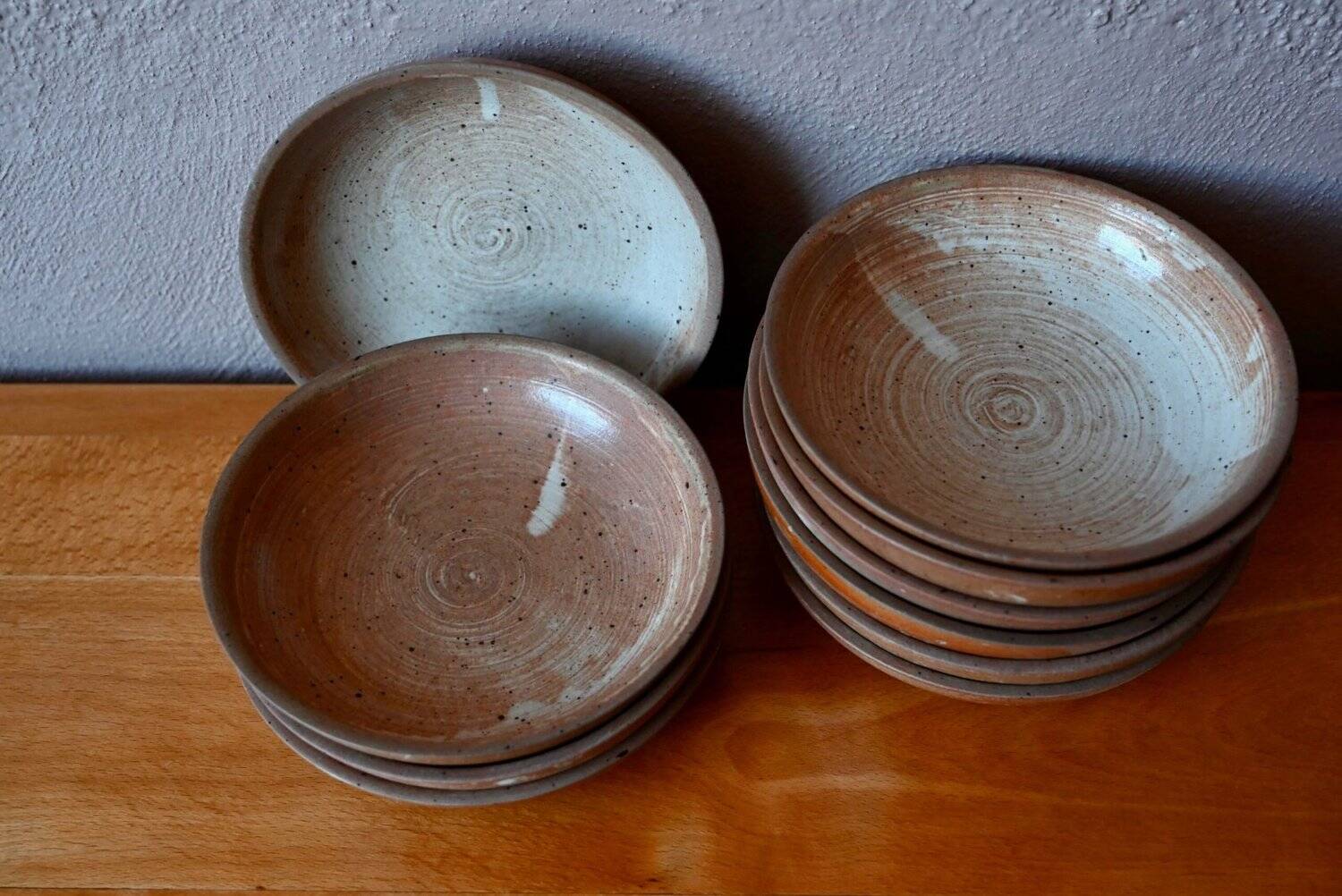Set of 10 turned stoneware plates, pyritised and glazed, wabi-sabi brutalist.
