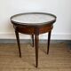 Louis XVI style bouillotte table in mahogany, white marble, and brass.