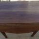 Table ronde ancienne à volets en bois noyer à roulettes
