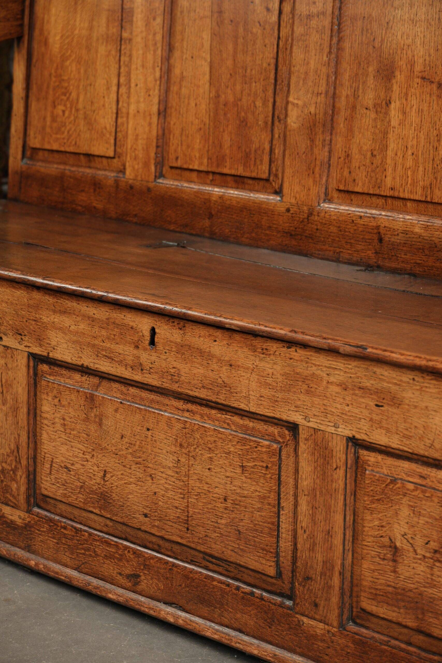 Antique English oak hall bench from the early 19th century with storage space