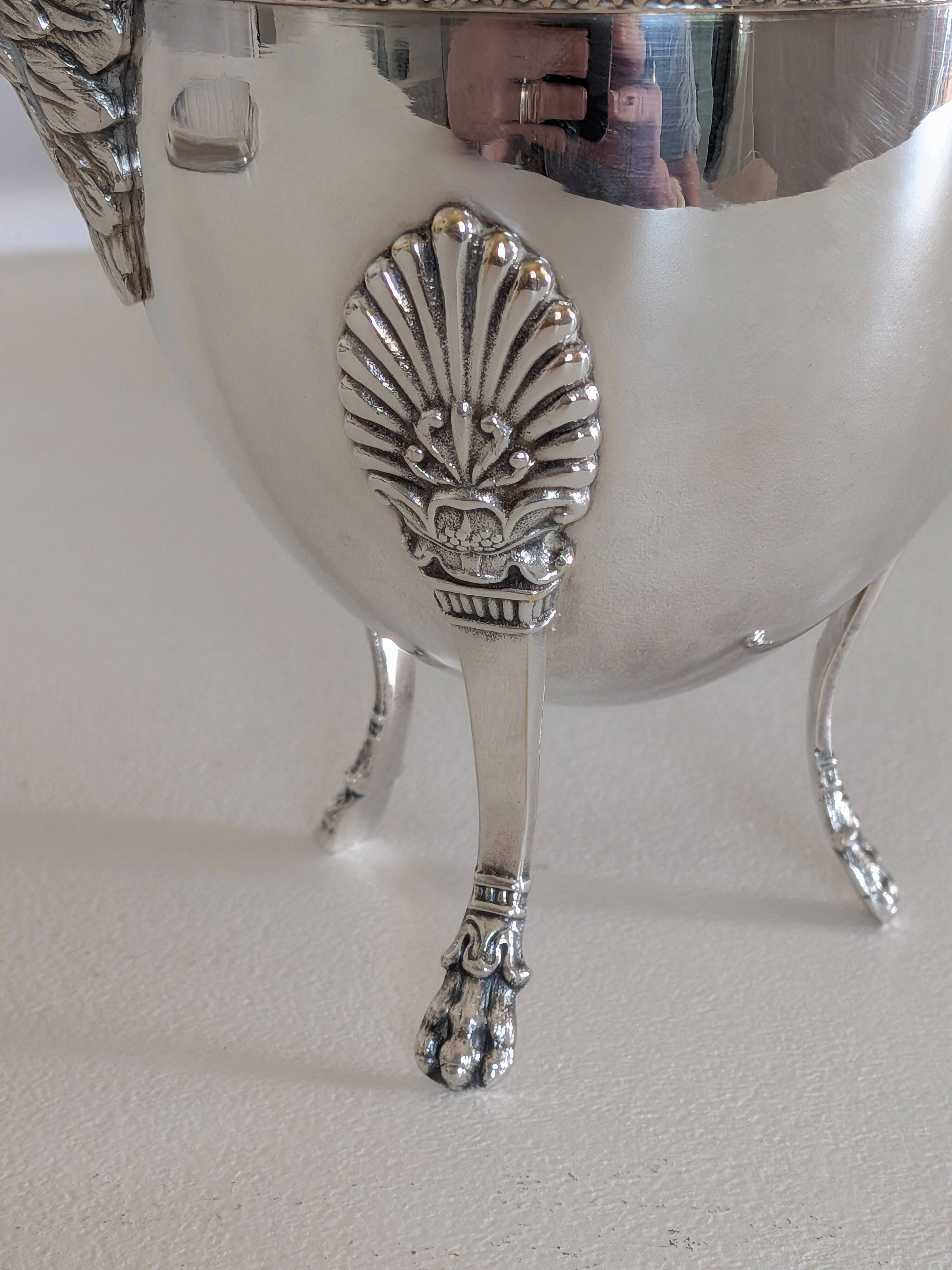 Empire-style silver-plated coffee pot with eagle head spout.