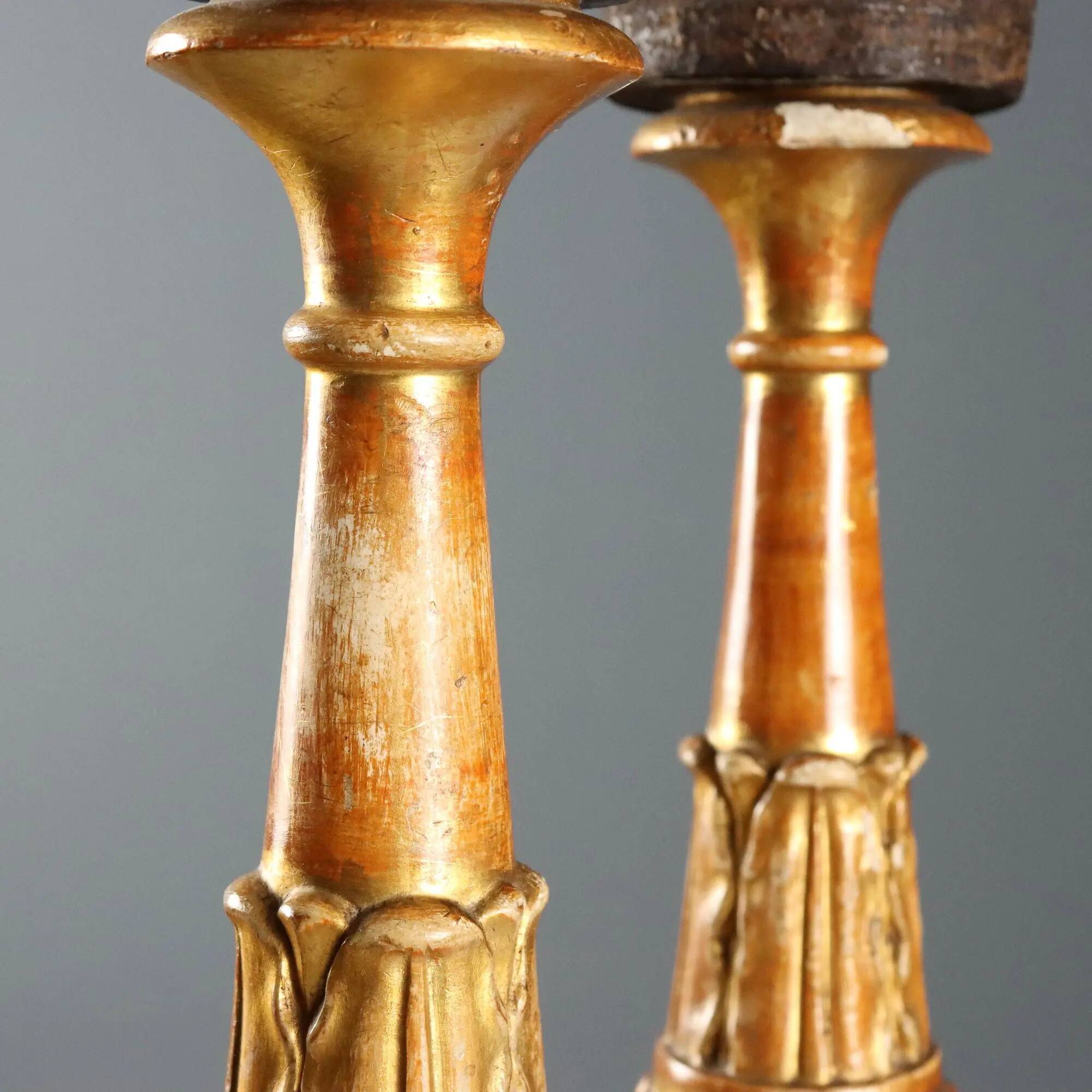 Pair of antique carved and gilded wooden candlesticks, Italy, 19th century.