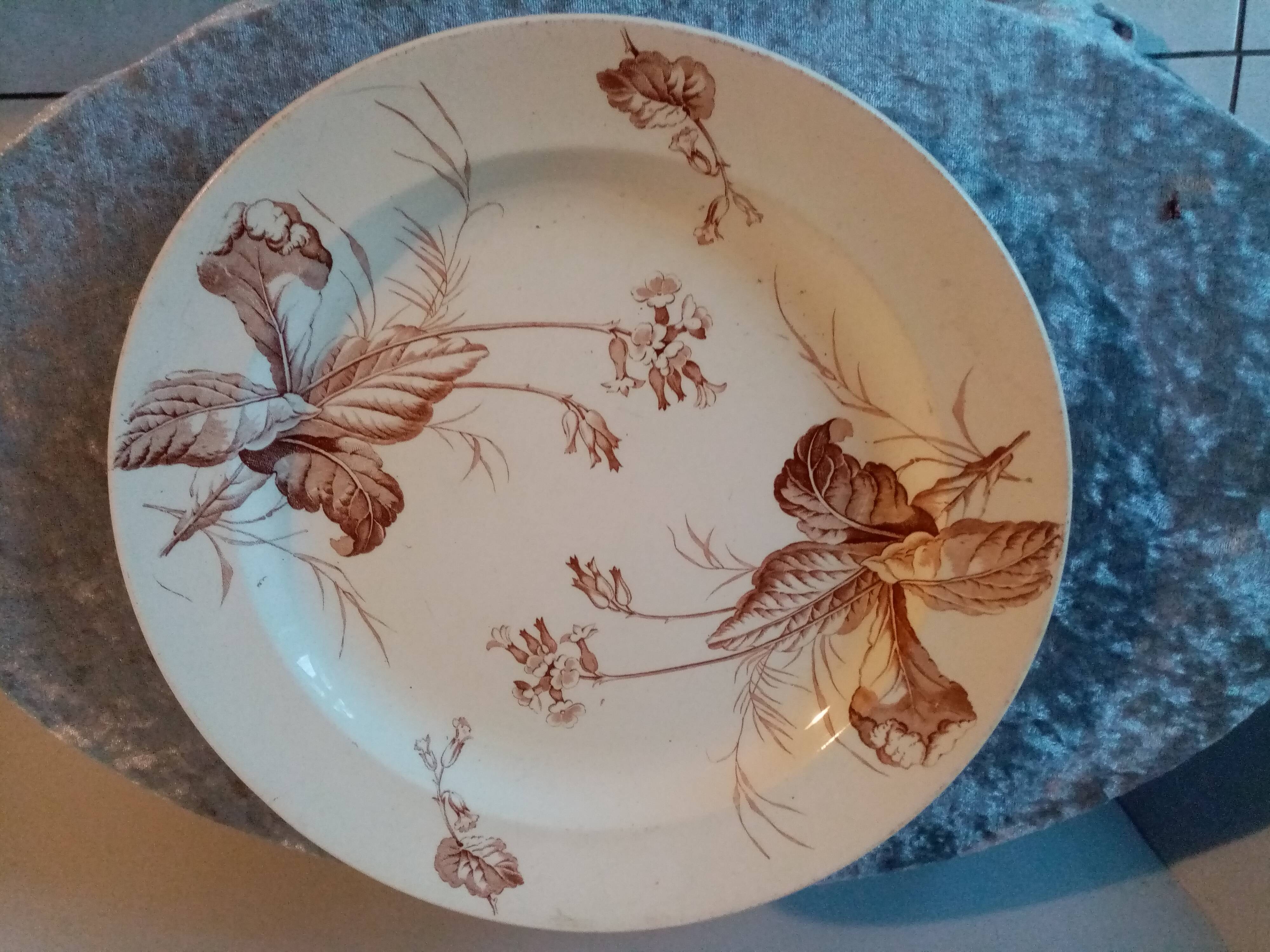 Old round earthenware dish from kg luneville with brown floral decoration