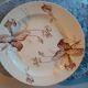 Old round earthenware dish from kg luneville with brown floral decoration