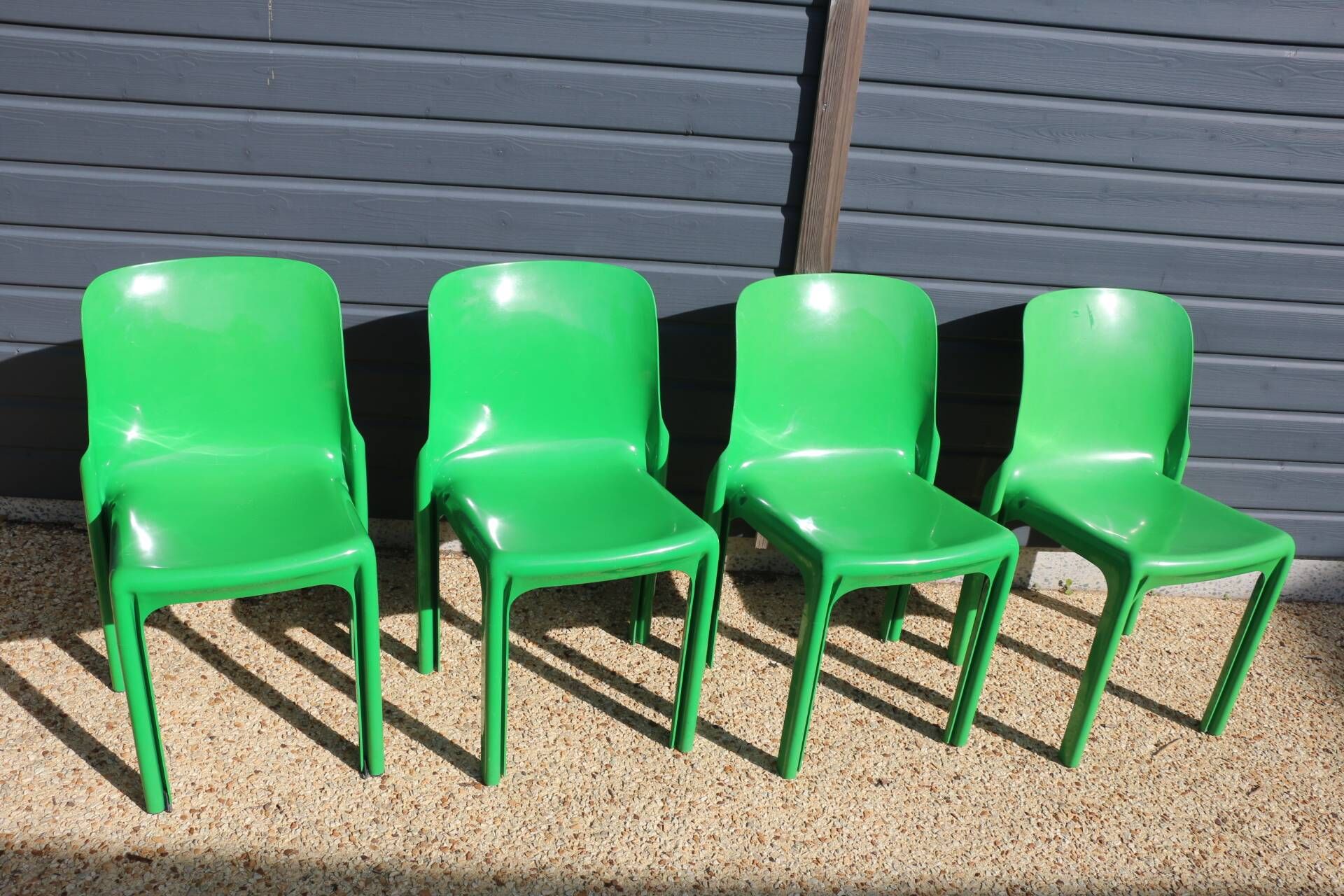 Set of 4 green Selene Magistretti chairs.