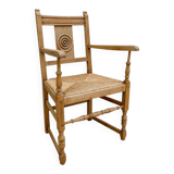 Light wood neo-Basque armchair with caned seat.