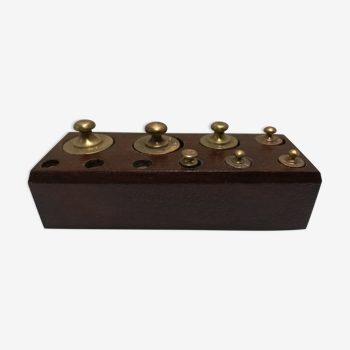 Brass weight on wooden base